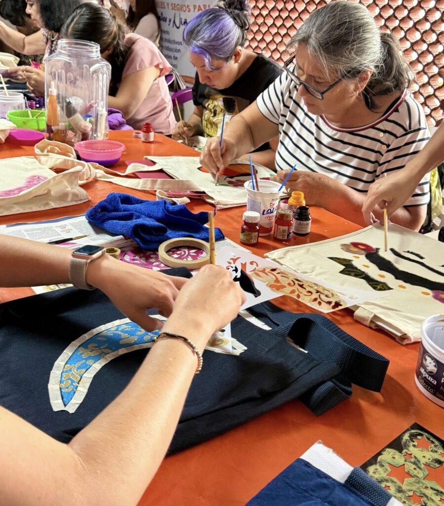Mujeres participando en Taller de pintura sobre bolsas de tela del IMC en Cuernavaca como parte del programa FAEM.